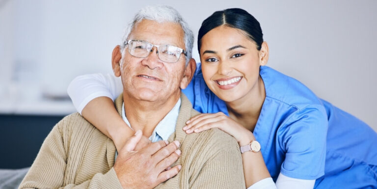 Senior Man with Female Nurse Receiving Support at Memory Care Facility